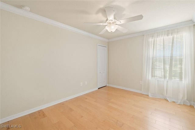 unfurnished room with light wood-style floors, ornamental molding, baseboards, and ceiling fan