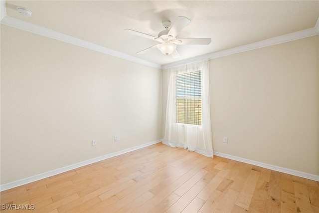 empty room with ornamental molding, ceiling fan, and light wood-type flooring