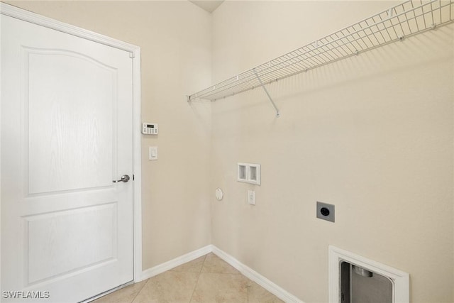 laundry area with light tile patterned flooring, hookup for a washing machine, laundry area, baseboards, and electric dryer hookup