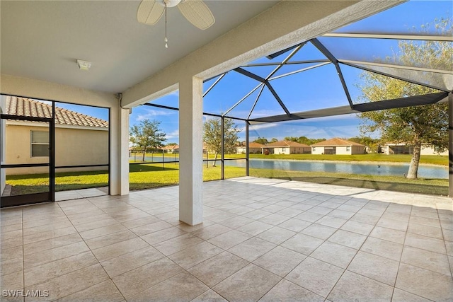 view of patio / terrace with a water view, a lanai, and a ceiling fan