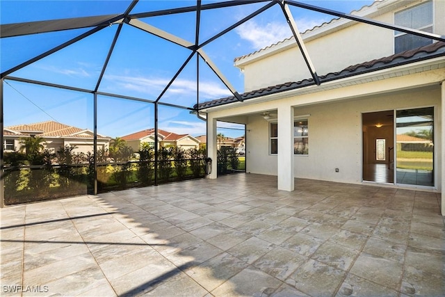 view of patio featuring glass enclosure