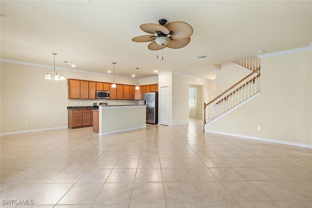 kitchen with stainless steel appliances, crown molding, pendant lighting, and light tile patterned floors