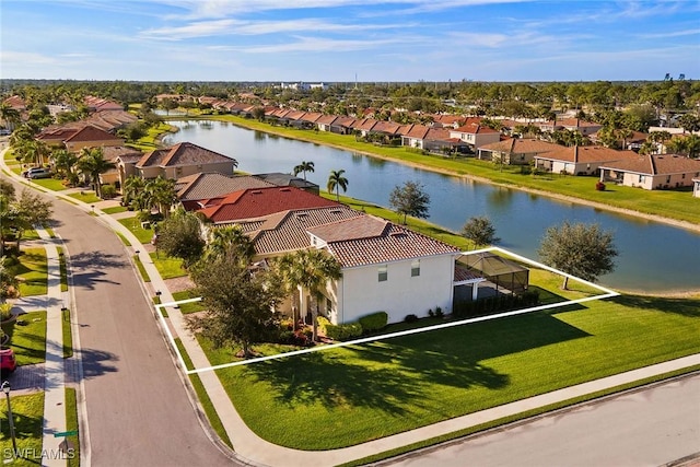 bird's eye view featuring a residential view and a water view