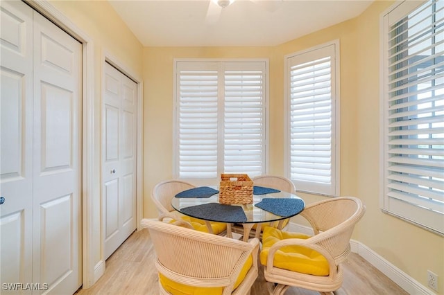 dining space with ceiling fan and light hardwood / wood-style floors