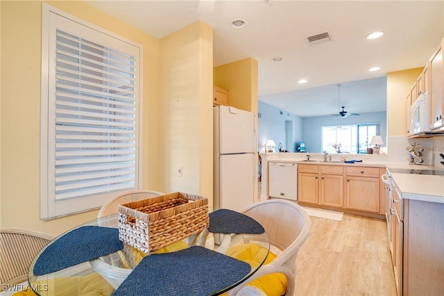 kitchen featuring light hardwood / wood-style floors, kitchen peninsula, ceiling fan, white appliances, and light brown cabinetry