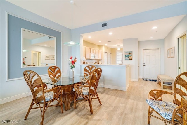 dining space with light hardwood / wood-style floors