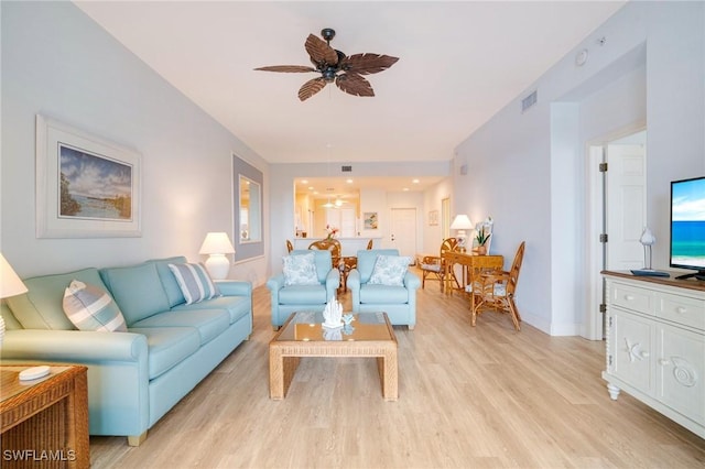 living room with ceiling fan and light hardwood / wood-style flooring