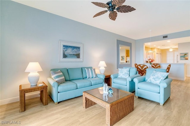 living room featuring ceiling fan and light wood-type flooring