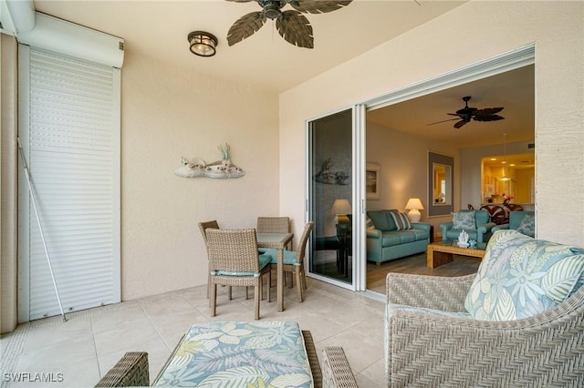 sunroom / solarium featuring ceiling fan