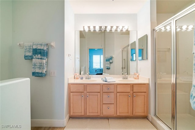 bathroom featuring vanity, tile patterned floors, and a shower with door