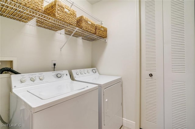 clothes washing area with washer and clothes dryer