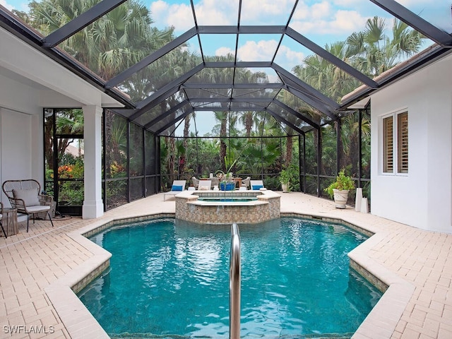 view of pool featuring an in ground hot tub, a lanai, and a patio