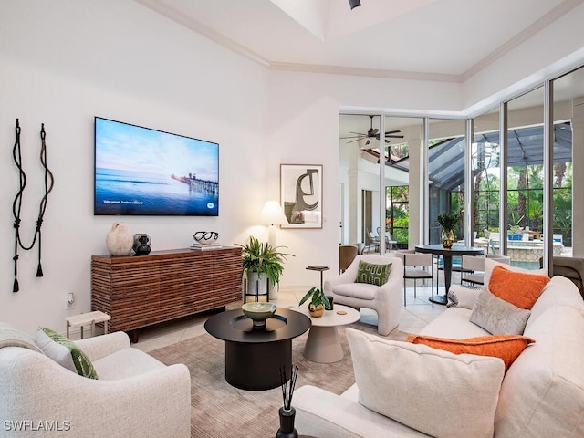 tiled living room with crown molding and ceiling fan