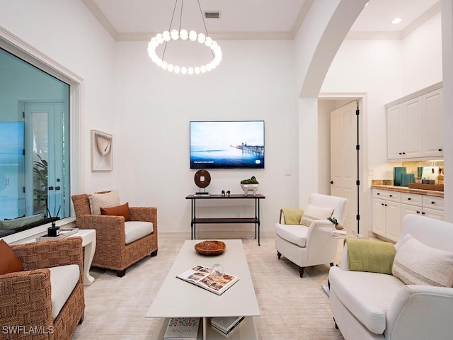 living room featuring ornamental molding and a high ceiling