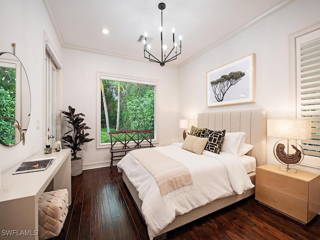 bedroom with an inviting chandelier, ornamental molding, and dark hardwood / wood-style flooring