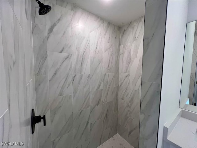 bathroom with tiled shower