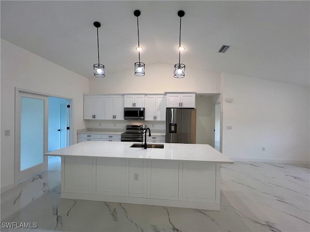 kitchen featuring pendant lighting, white cabinets, stainless steel appliances, and vaulted ceiling