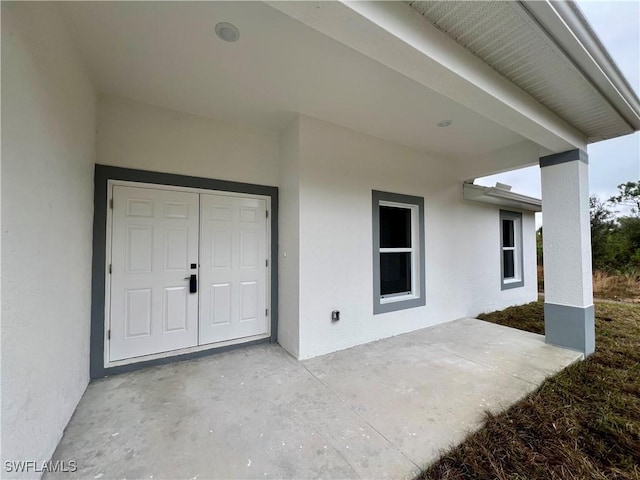 property entrance with a patio