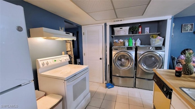 laundry room with sink, light tile patterned floors, and washing machine and clothes dryer