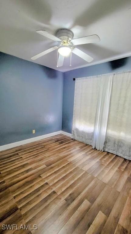 unfurnished room with ceiling fan and hardwood / wood-style flooring