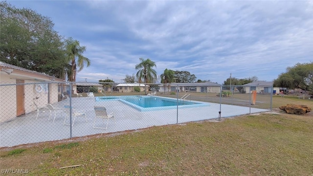 view of pool with a yard and a patio