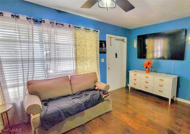 living room with ceiling fan and dark hardwood / wood-style floors