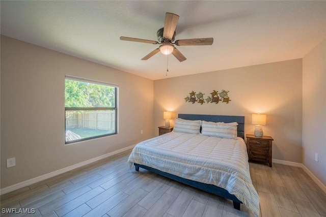 bedroom with ceiling fan and light hardwood / wood-style floors