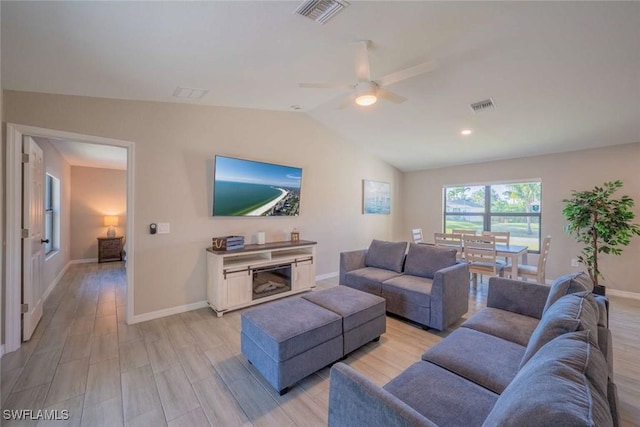 living room featuring light wood-type flooring, ceiling fan, and lofted ceiling