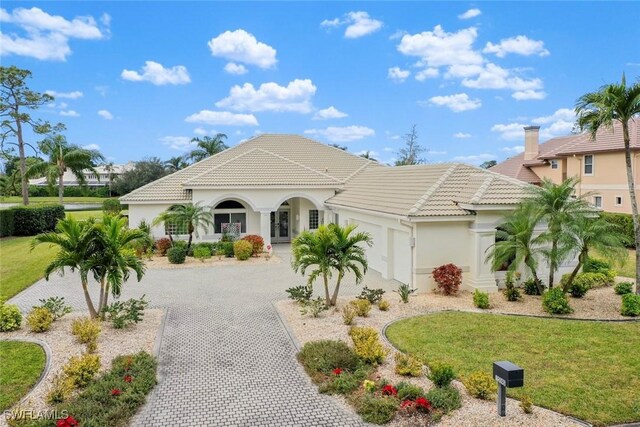 mediterranean / spanish-style house with a front yard