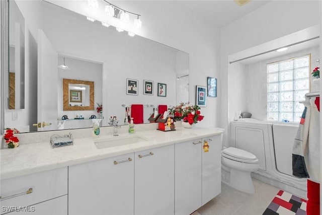 bathroom featuring toilet, vanity, and tile patterned flooring