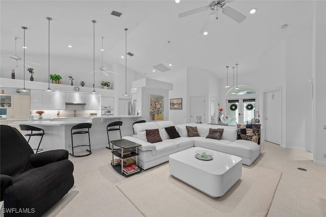 living room featuring high vaulted ceiling, french doors, light tile patterned floors, and ceiling fan