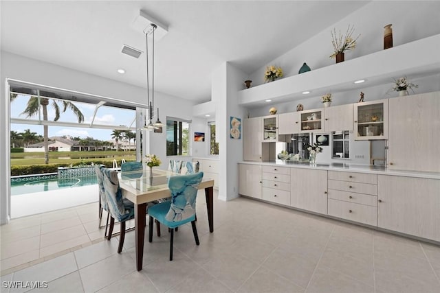 tiled dining area with lofted ceiling