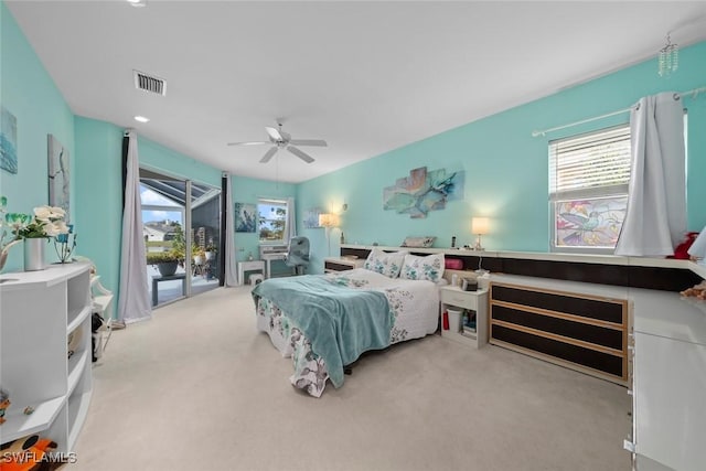 carpeted bedroom with ceiling fan and access to exterior