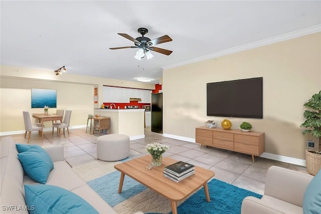 tiled living room with ornamental molding and ceiling fan