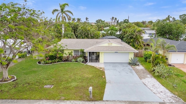 single story home featuring a garage and a front yard