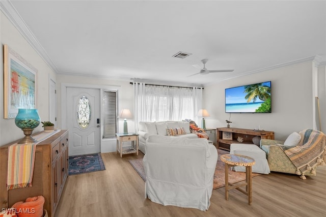 living room with ceiling fan, ornamental molding, and light hardwood / wood-style floors