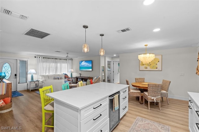 kitchen with white cabinetry, hanging light fixtures, and light hardwood / wood-style floors