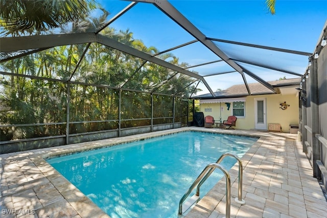 view of pool with a lanai and a patio