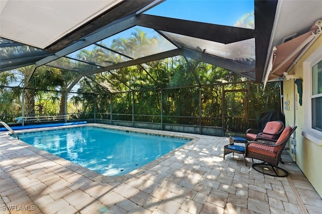 view of pool featuring a patio and glass enclosure