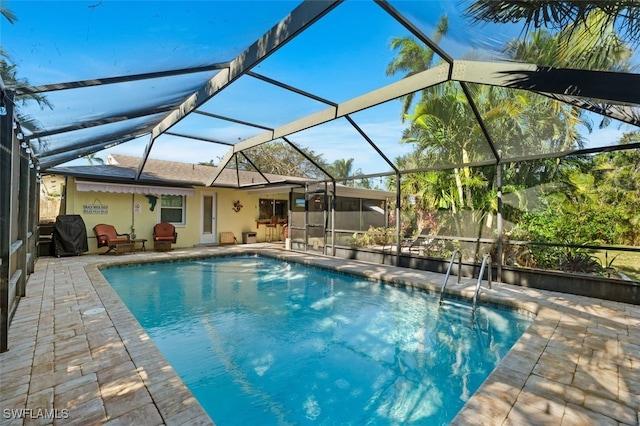 view of pool with a lanai and a patio