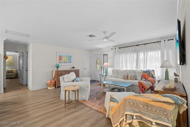 living room featuring crown molding, ceiling fan, and light wood-type flooring