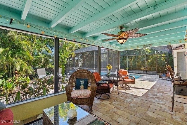 sunroom / solarium with ceiling fan and beam ceiling