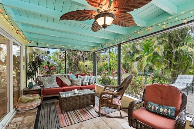 sunroom / solarium with ceiling fan and beam ceiling