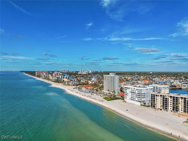 birds eye view of property with a view of the beach and a water view