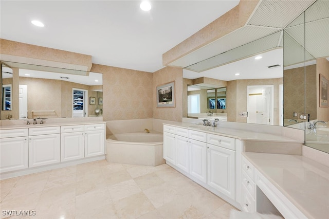 9811 Gulf Shore Dr Unit 301, Naples, FL 34108 - bathroom with a bath, two vanities, and recessed lighting