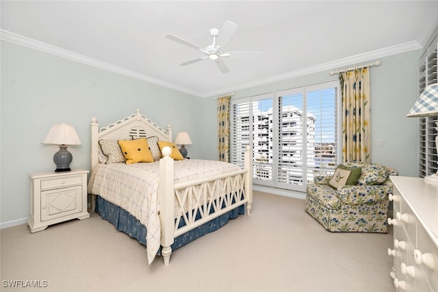 carpeted bedroom with ornamental molding and ceiling fan