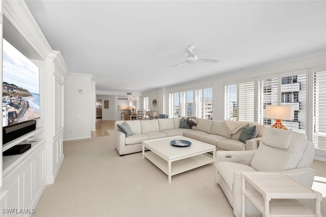 carpeted living room with crown molding and ceiling fan