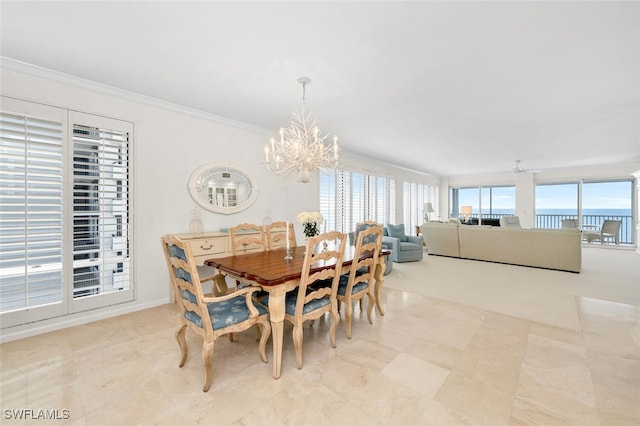 dining area with crown molding, a wealth of natural light, and a chandelier