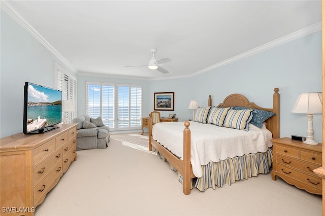 bedroom featuring ornamental molding, light carpet, and ceiling fan