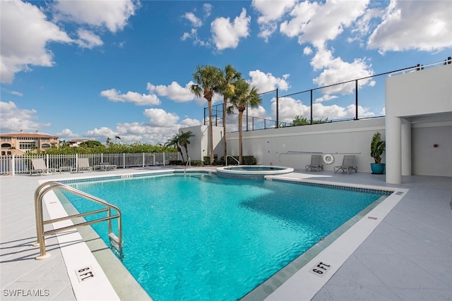 view of swimming pool with a community hot tub and a patio area